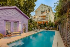 a house with a swimming pool in front of a house at Palazzo Hudson - Luxury Pool, Hot Tub, and Sauna in Hudson