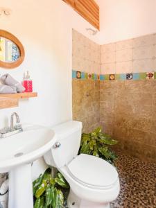 a bathroom with a toilet and a sink at Green Studio at Casa Cacao with Terrace and Starlink in Brisas de Zicatela