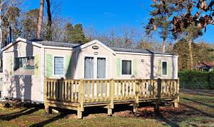 a tiny house with a wooden fence in a yard at Tin in Marcilly-sur-Eure