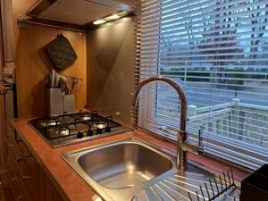 a kitchen with a sink and a stove and a window at Tin in Marcilly-sur-Eure