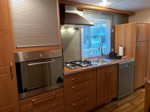 a kitchen with a stove top oven next to a window at Tin in Marcilly-sur-Eure +11 photos