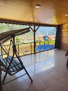 Habitación con balcón con vistas a un parque infantil. en EŞ Pansiyon, en Uzungöl