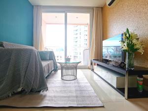a living room with a bed and a fish tank at Caribbean Water Park Hotel in Pattaya South