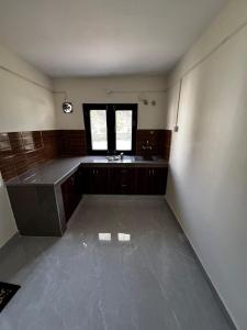 an empty kitchen with a sink and a window at Nal Damyanti Homestay in Bhīm Tāl