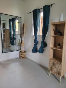 a room with blue curtains and a mirror at Paradise House in Saint-François +9 photos
