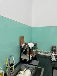 a kitchen with a sink and a counter with dishes at Mơ Homestay - View Biển Ninh Thuận in Thôn Khánh Nhơn +27 photos
