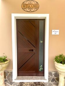 a wooden door in a building with two pots at Villa Francesca in Pula