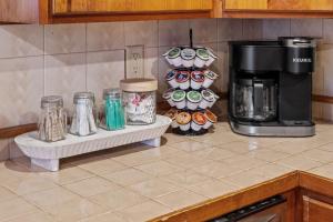 a kitchen counter with a coffeemaker and a coffee maker at Lucky Log Cabin Hottub fireplace 12min to Mt Snow in Wardsboro