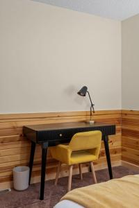 a desk with a lamp and a yellow chair in a room at Lucky Log Cabin Hottub fireplace 12min to Mt Snow in Wardsboro +44 photos