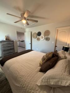 a bedroom with a bed and a ceiling fan at Cozy Haven Apartment in Clovis