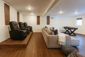 a living room with a couch and chairs and a table at Drift Haus 4.5BR Mountain Lodge in Windham