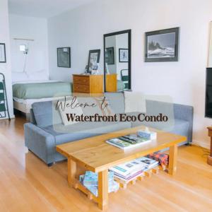 a living room with a couch and a coffee table at Tofino Eco Waterfront Condo in Tofino
