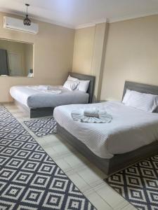 Voodi või voodid majutusasutuse Jazal Pyramids View Hotel toas