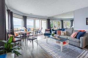 a living room with a couch and a table at Beachfront Serenity 101 in Traverse City +49 photos