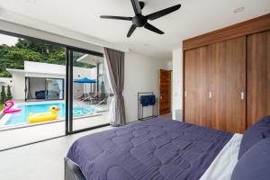 a bedroom with a bed and a swimming pool at Villa Sabai Lamai in Ban Thung +21 photos