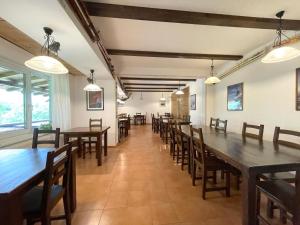 a dining room with wooden tables and chairs at Pensiunea Cehov in Bran +37 photos