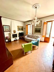 a large living room with a bed and a chandelier at Casa Ave in Viareggio