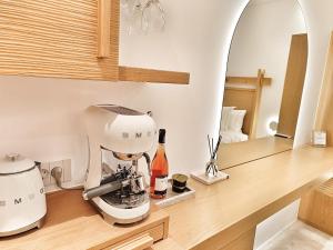 a kitchen counter with a mixer and a bottle of wine at DelMar Suites Syros in Finikas