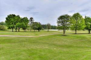 a golf course with trees and a path at Renovated 2BR by Riverwalk & Medical District in North Augusta