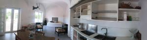 a kitchen with a sink and a table in a room at La Pica Marina Anacapri in Anacapri