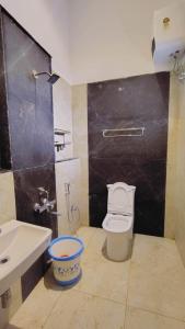 a bathroom with a white toilet and a sink at ST Kodai Heaven Stay in Kodaikānāl