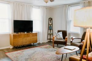 a living room with a flat screen tv on a dresser at Spacious Home Near Lake MI w Fire Pit in Sheboygan