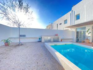 a swimming pool in the backyard of a house at Casa2patis in Poblenou del Delta