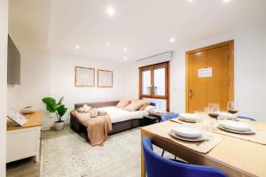 a living room with a couch and a table at Casa Goya Vírgenes in Zaragoza