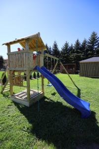 a playground with a slide and a play structure at Apartamenty Polna Przystań in Stronie Śląskie