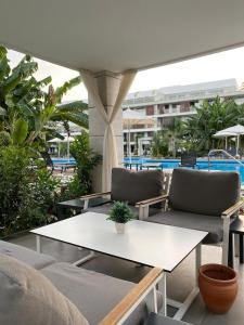 a patio with two couches and a table with a table at Luxury studio room - in Courtyard Holiday Resort in İskele