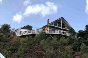 a house sitting on top of a hill at Seaside Cabin with panoramic view in Bømlo