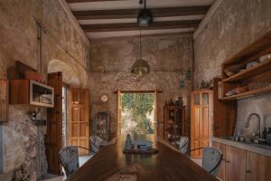a kitchen with a large wooden table in a room at Luxury Suite by Casa Zotz in Campeche