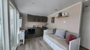a living room with a couch in a kitchen at House with a spectacular view over Torne river in Kiruna +8 photos