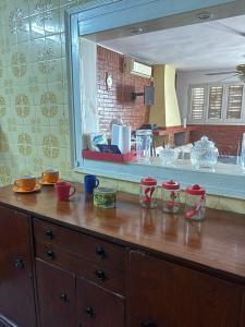 a kitchen with a wooden dresser with a mirror at La Magallanes in Santiago del Estero