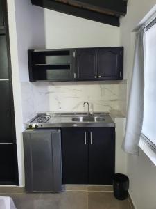 a kitchen with a sink and a counter top at Mini Aptoestudio para 2 personas in Cúcuta