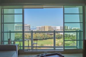 a living room with a view of the city through a window at Beautiful Seibal Stay w Vidanta Resort Access in Nuevo Vallarta  +45 photos