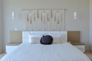 a bedroom with a large white bed with white pillows at Beautiful Seibal Stay w Vidanta Resort Access in Nuevo Vallarta 