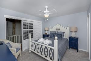 a bedroom with a bed and a ceiling fan at 1120 Duneside Villa by Akers Ellis Rentals in Kiawah Island +36 photos