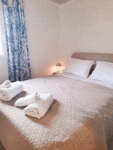 a bedroom with a bed with towels on it at The Getaway in Sálakos