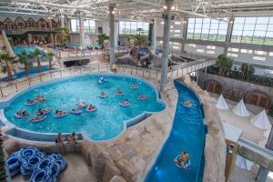 a group of people in a pool at a water park at Apartament Bianco - Aquapark in Rumia