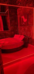 a red room with two beds with red lighting at L'H LION's RED SUITE in Castrovillari +7 photos