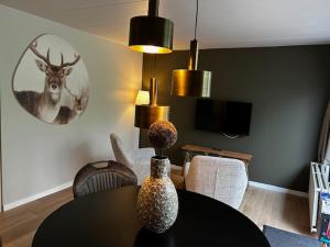 a dining room with a table and a deer on the wall at Hotel & Restaurant Wildthout in Ommen