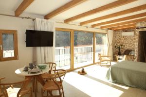 a bedroom with a bed and a table and a television at Paraiso Suit Casas Lacambra in Tolosa