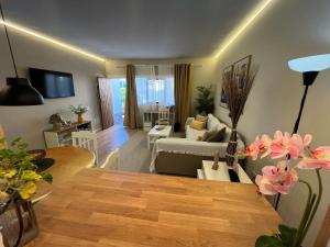 a living room with a table and a living room at Oasis del Puerto Spacious Premium Apartment in Puerto de la Cruz