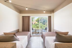 a bedroom with two beds and a large window at tent Capi Playa in Playa de Palma