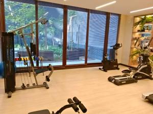 a gym with exercise equipment and a large window at Rosas Comfort 409 in Santiago