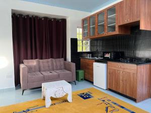 a living room with a couch and a table at Kijani Holiday Home in Nanyuki