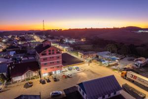 an aerial view of a city at sunset at Hotel Cesa in São José dos Ausentes