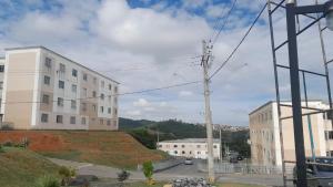 a white building on a hill next to a street at AP ALPHA 5 STAr in Vespasiano