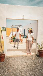 a man and a woman standing in a doorway at IBI Surf House in Sidi Kaouki